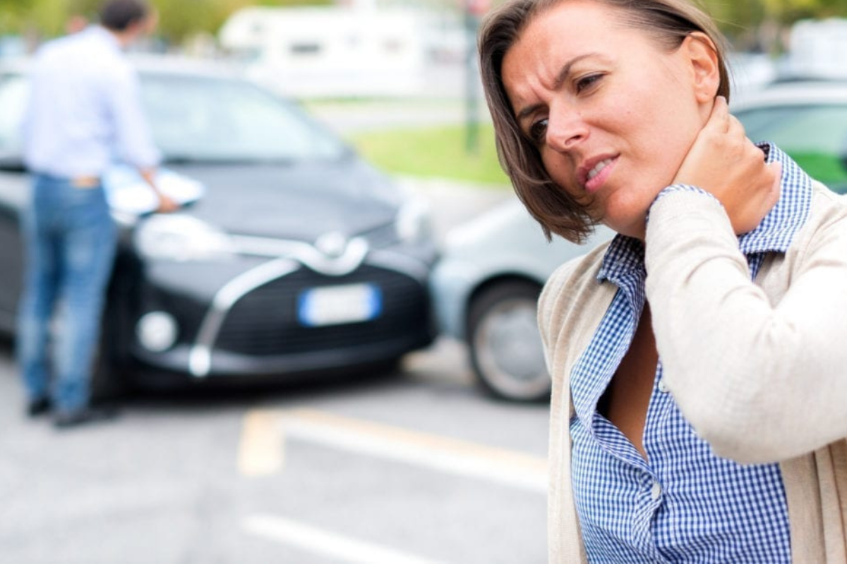 Person experiencing back and neck pain after a car accident in Florida