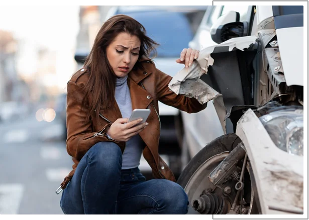 Injured person reviewing phone after a car accident, considering an insurance adjuster call